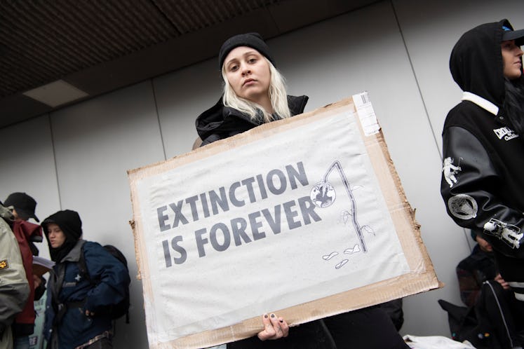 15 April 2023, Berlin: A participant in the demonstration by the climate protection group Extinction...