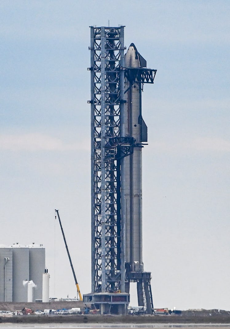 The SpaceX Starship spacecraft sits on a Super Heavy rocket booster at the company's Launch facility...