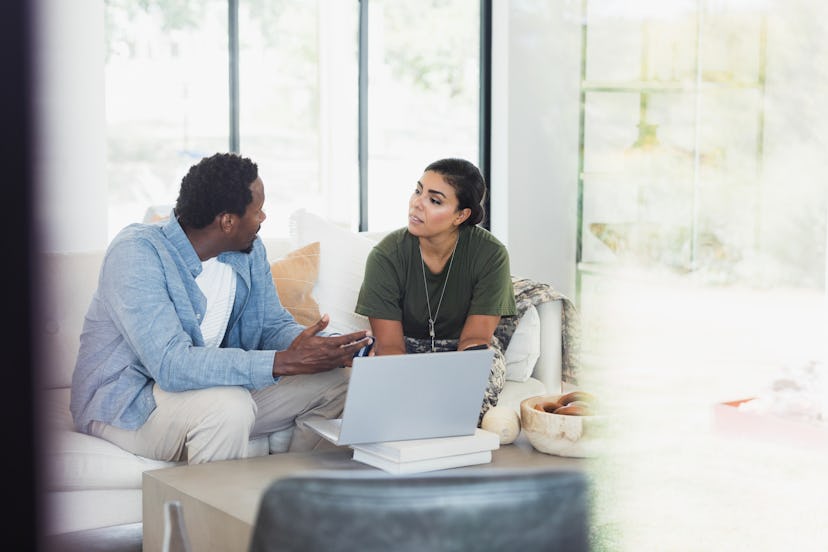 The mid adult man and his soldier wife have a serious discussion about spending.