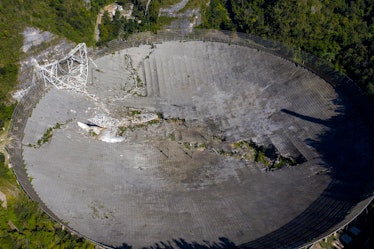 This aerial view shows the damage at the Arecibo Observatory after one of the main cables holding th...