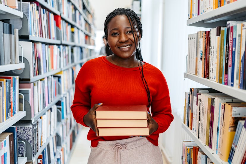 Portrait of a beautiful young black woman in a student library in college.