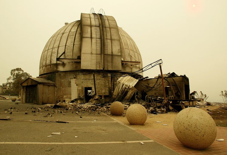 The historic Mount Stromlo Observatory operated by The Australian National University lies in ruins ...