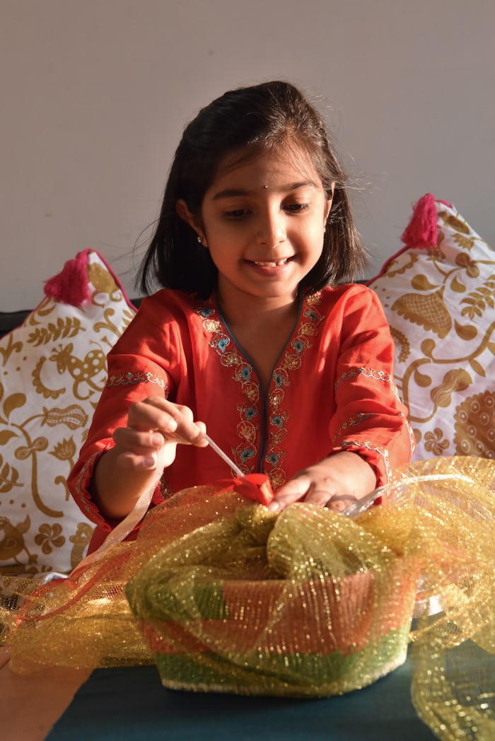 a girl putting together a memorable, meaningful mother's day gift basket with these ideas