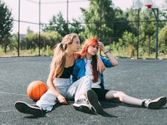two friends sit on basketball court with a basketball, as they consider the May 2023 flower lunar ec...
