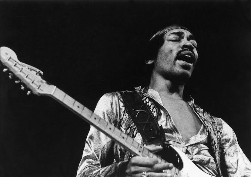 Music baby names inspiration and musical artist Jimi Hendrix performs on stage.