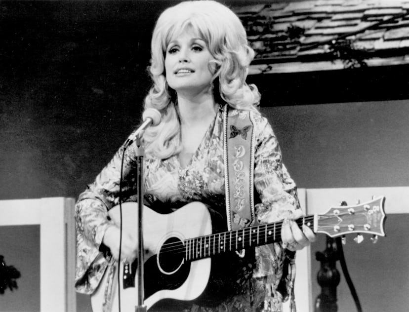 Music baby names inspiration and country singer Dolly Parton performs onstage with an acoustic guita...