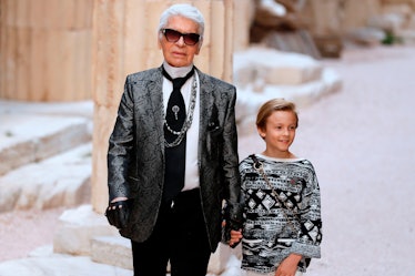 German fashion designer Karl Lagerfeld acknowledges the audience with his godson Hudson Kroenig 