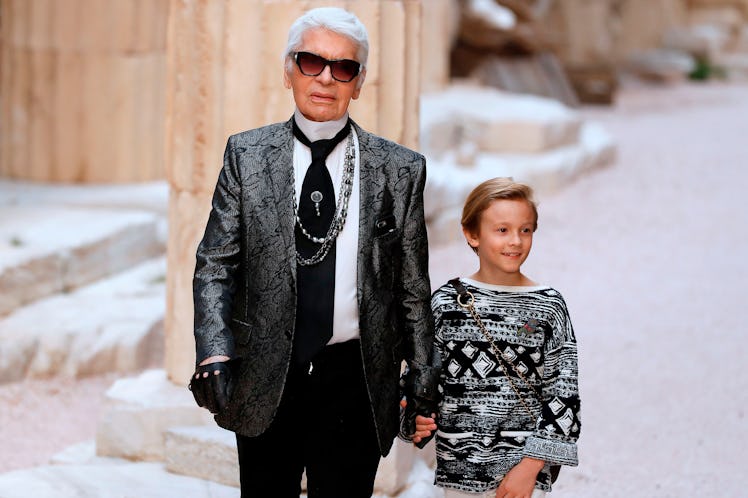 German fashion designer Karl Lagerfeld acknowledges the audience with his godson Hudson Kroenig 