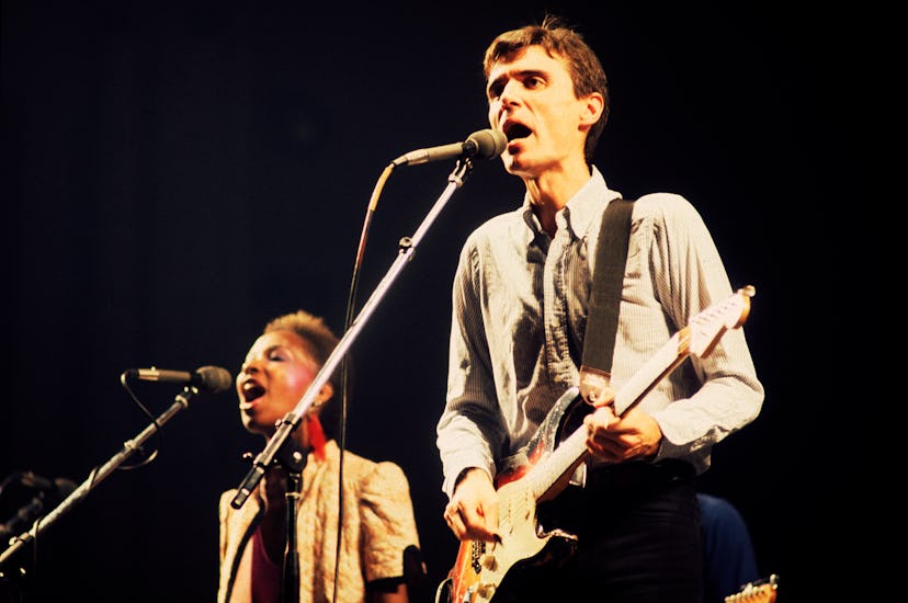 David Byrne, of the group Talking Heads, plays guitar as he performs onstage at the Aragon Ballroom,...