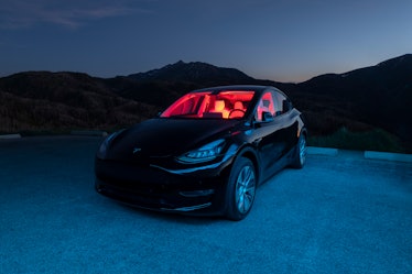 A black 2020 Tesla Model Y car in the mountains of Utah after dusk with interesting interior/exterio...