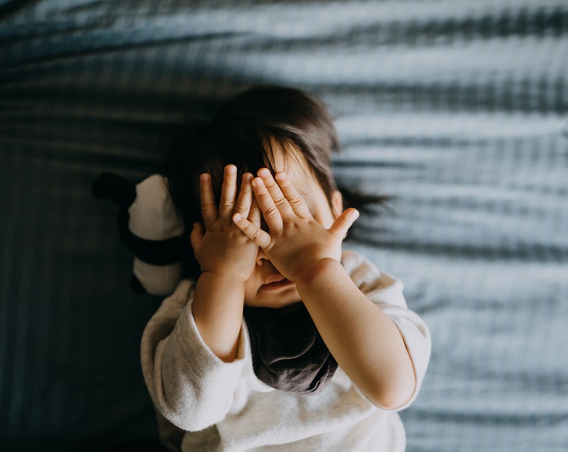 cute toddler in bed in an article about how long does the 18 month sleep regression last?