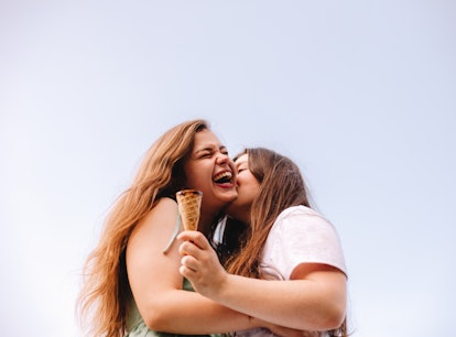 two young women share a kiss after eating ice cream, as they consider how the may 2023 black moon wi...