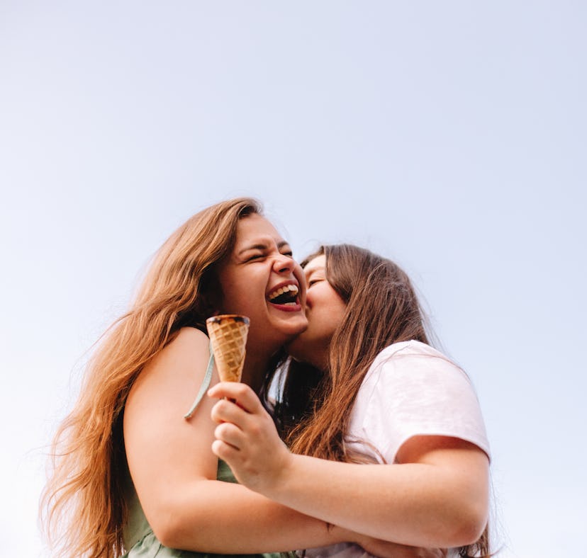 two young women share a kiss after eating ice cream, as they consider how the may 2023 black moon wi...