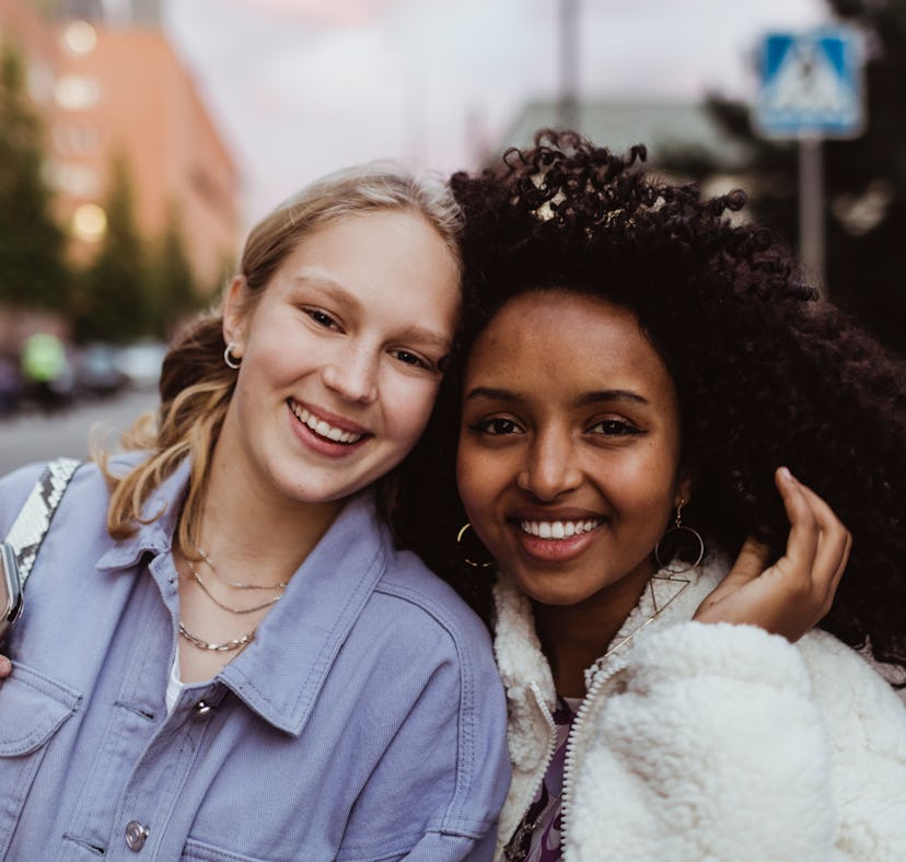 two friends pose for a photo together as they consider how the May 2023 black moon will affect their...