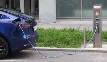 A Tesla electric vehicle is charged at a public charging station on April 27, 2023 in Vienna, Austri...