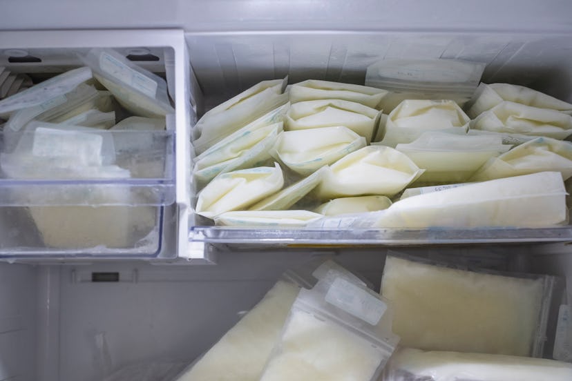 flattened bags of frozen breast milk stacked in the freezer in article about how to properly store b...