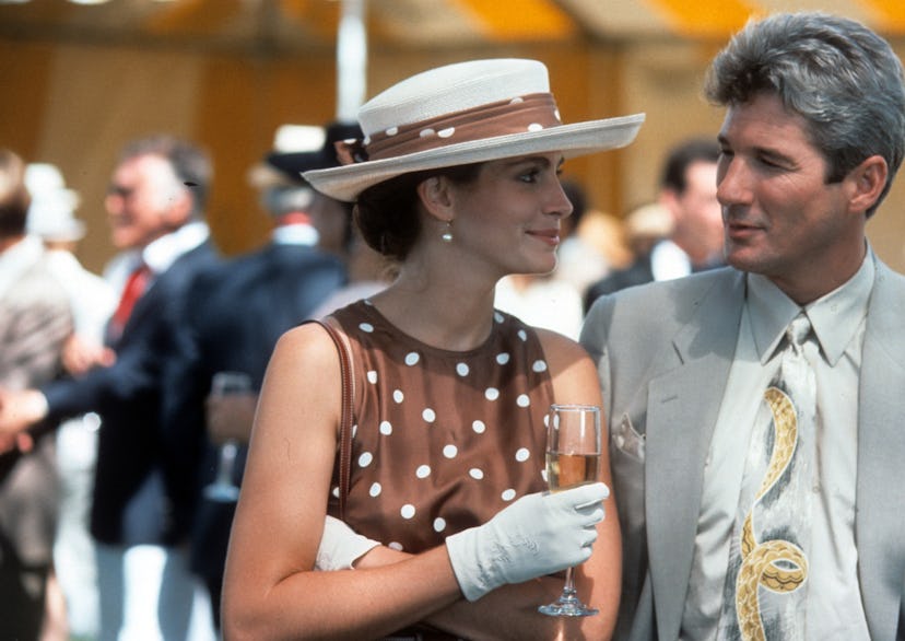 Julia Roberts has a drink with Richard Gere in a scene from the film 'Pretty Woman', 1990. (Photo by...