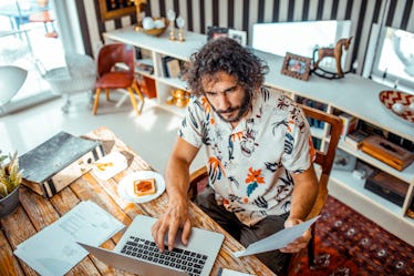 A man working on his taxes on his laptop from home.