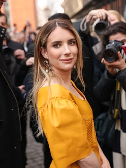 Emma Roberts blonde hair dark roots at Paris Fashion Week 2023