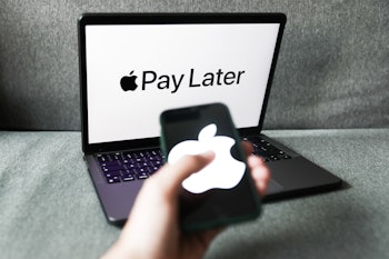 Apple Pay Later logo displayed on a laptop screen and Apple logo displayed on a phone screen are see...