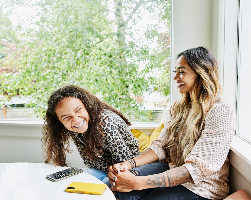 mom and child laughing together at mother's day jokes