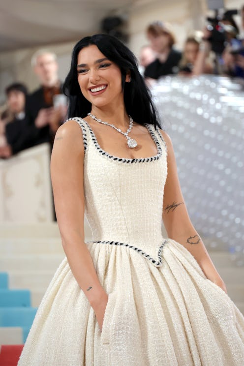 Dua Lipa attends The 2023 Met Gala in a white ball gown