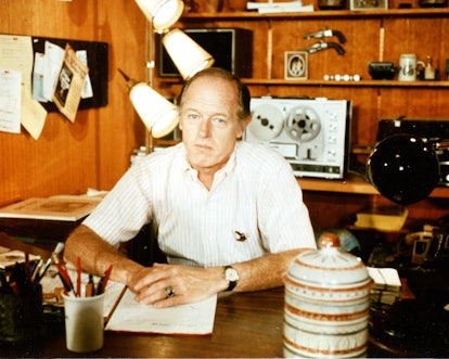 Portrait of American intelligence officer and writer E Howard Hunt (1918 - 2007) as he sits at a des...