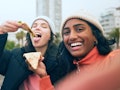 two friends enjoy pizza together as they take a selfie and consider how the May 2023 black moon will...