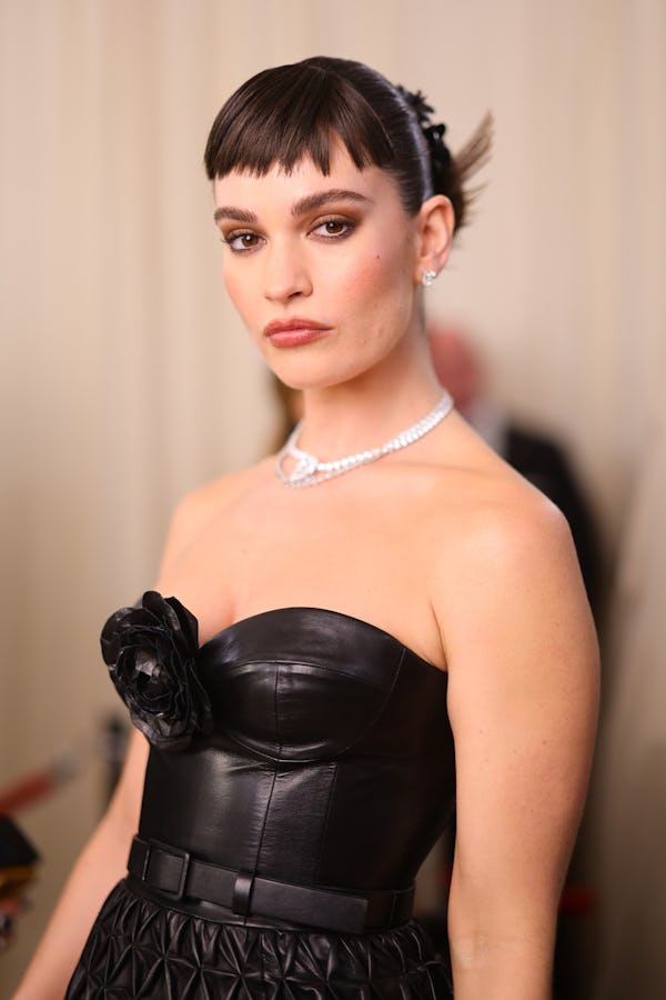 Lily James attends The 2023 Met Gala with new micro bangs.