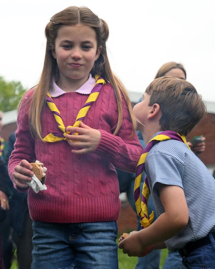 Britain's Princess Charlotte of Wales (R) and her brother Britain's Prince Louis of Wales (R) eat ma...