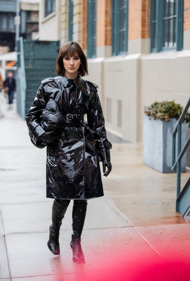 Model Hari Nef is seen wearing black vinyl coat, bag outside Khaite during New York Fashion Week on ...