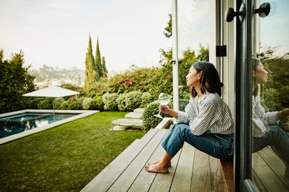 a women enjoying a glass of wine, which is not a food to avoid while breastfeeding