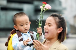 RENHUAI, CHINA - MAY 12, 2023 - A happy smile is seen on the face of a mother who received flowers a...