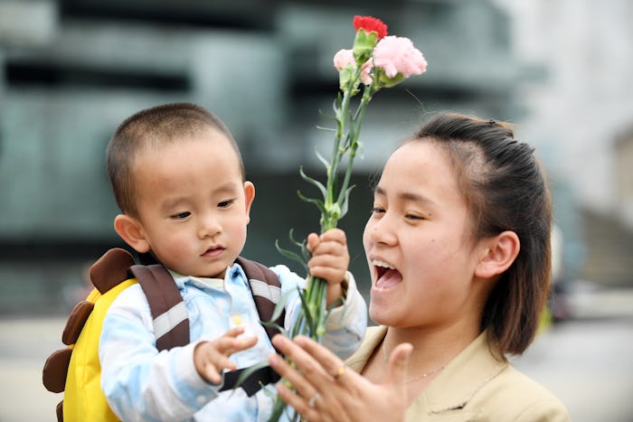 RENHUAI, CHINA - MAY 12, 2023 - A happy smile is seen on the face of a mother who received flowers a...