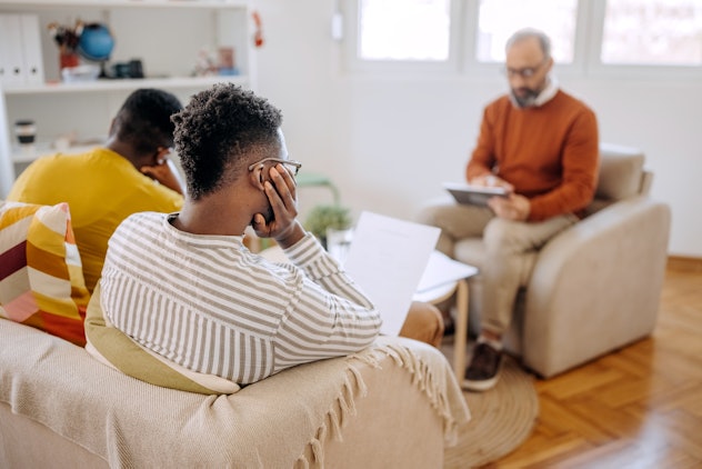 Worried couple reading paperwork in psychiatrist office, in an article about signs your marriage wil...