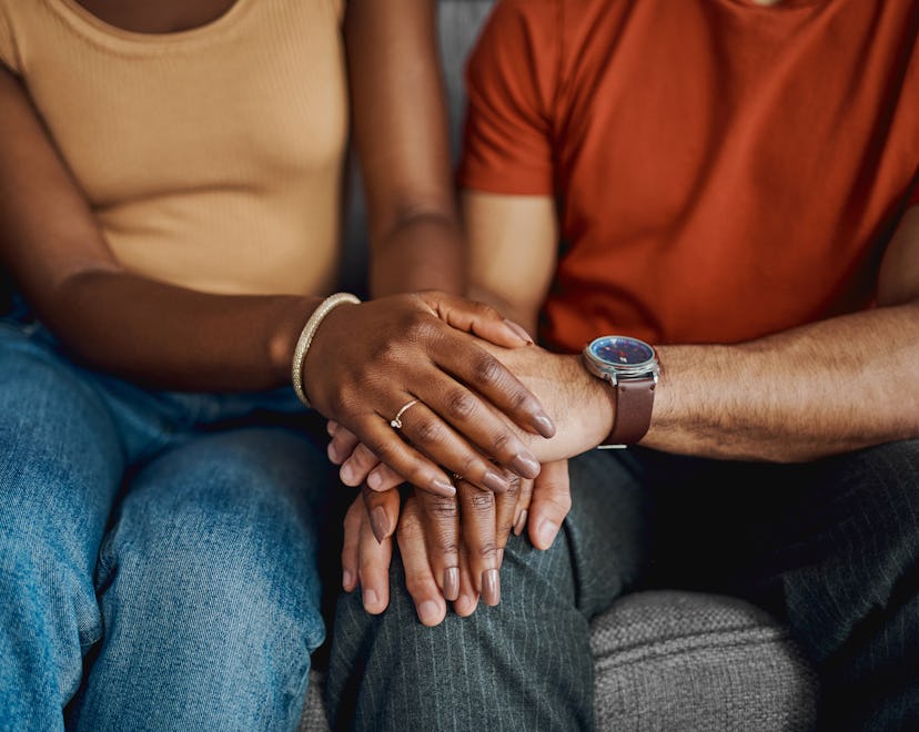 a couple holds hands, in a list of signs your marriage can survive infidelity