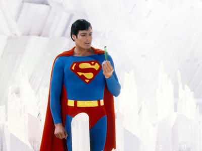Superman, played by American actor Christopher Reeve (1952 - 2004), holds a green crystal at the For...
