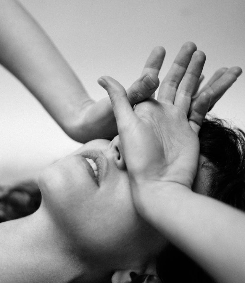 black and white closeup of woman stressed; physical symptoms of negative energy in the body