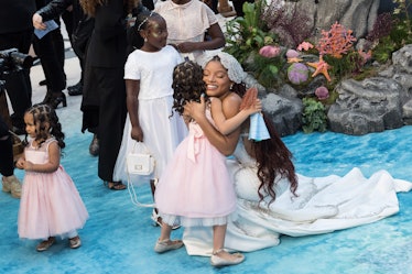 LONDON, UNITED KINGDOM - MAY 15: Halle Bailey embraces a young girl as she attends the UK premiere o...