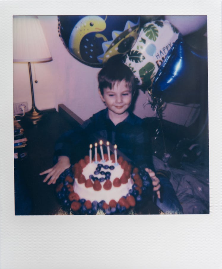 Child with birthday cake. Polaroid photo.