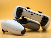 Two dualsense controllers of the Playstation 5. (Photo by Nikos Pekiaridis/NurPhoto via Getty Images...