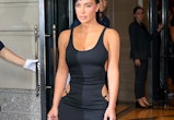 Kim Kardashian wears a bodycon dress with visible thong straps.
