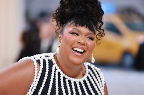 Lizzo claps back at rude fan tweet about her 2023 Met Gala performance outfit.