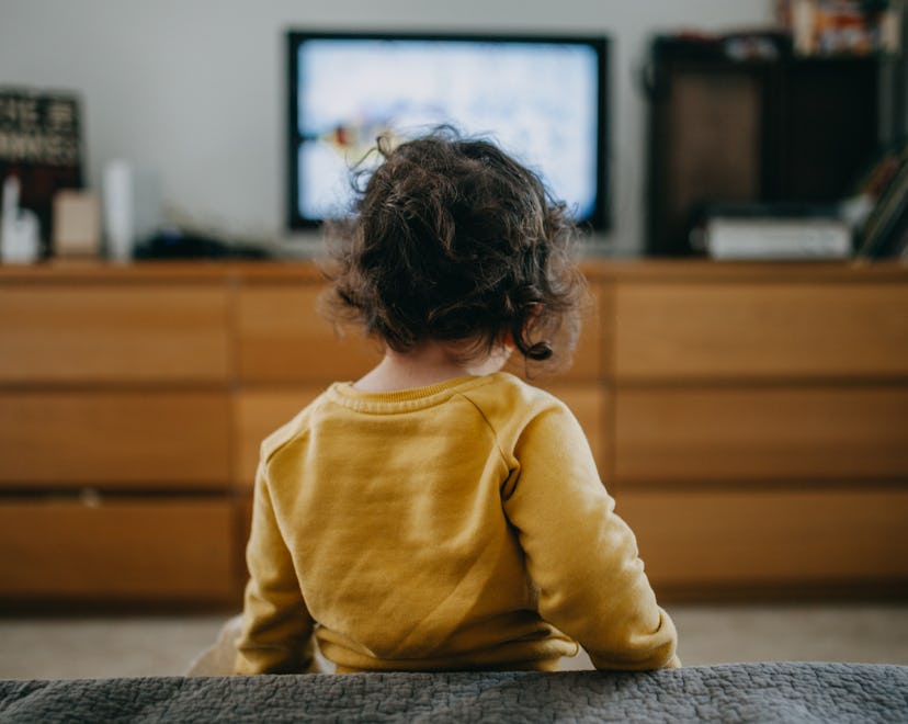 What is frame rate in kids' shows? A toddler stands watching a TV across the living room.