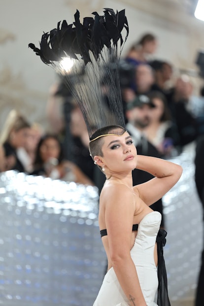 Florence Pugh attends The 2023 Met Gala with a freshly shaved head.