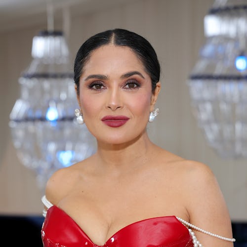 Salma Hayek with a berry lip and sleek ponytail at the 2023 met gala