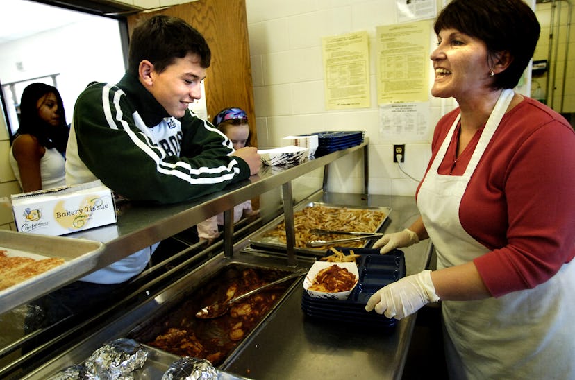 Robin Eckmann, left, 13, chats with Liz Brooks (cq both) while she serves him ravioli and fries in t...