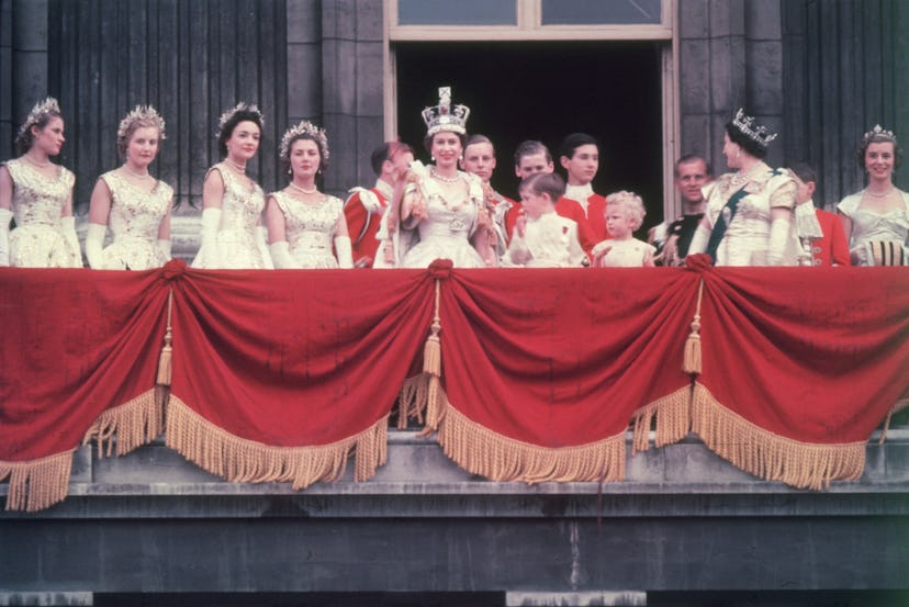 2nd June 1953:  The newly crowned Queen Elizabeth II waves to the crowd from the balcony at Buckingh...