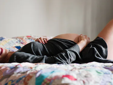 pregnant woman lying in bed; can you have an orgasm on pelvic rest
