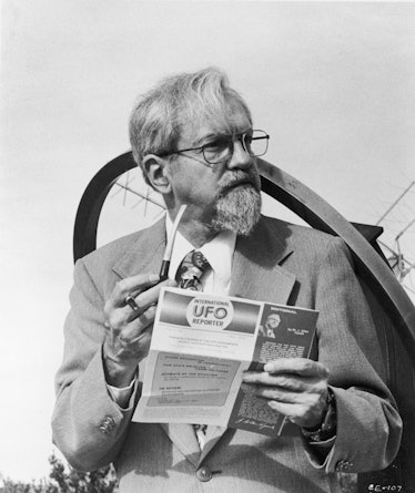 UFO expert Dr. J. Allen Hynek holds a pipe and one of his magazine editorials while serving as techn...
